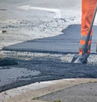 Worker in an orange uniform during a road repair